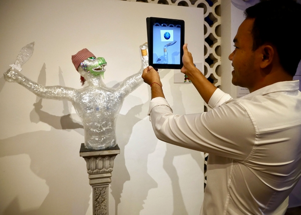 A Hanuman scupture build by the Plastic Commune team triggers an augmented reality image of the earth carried in his hand.